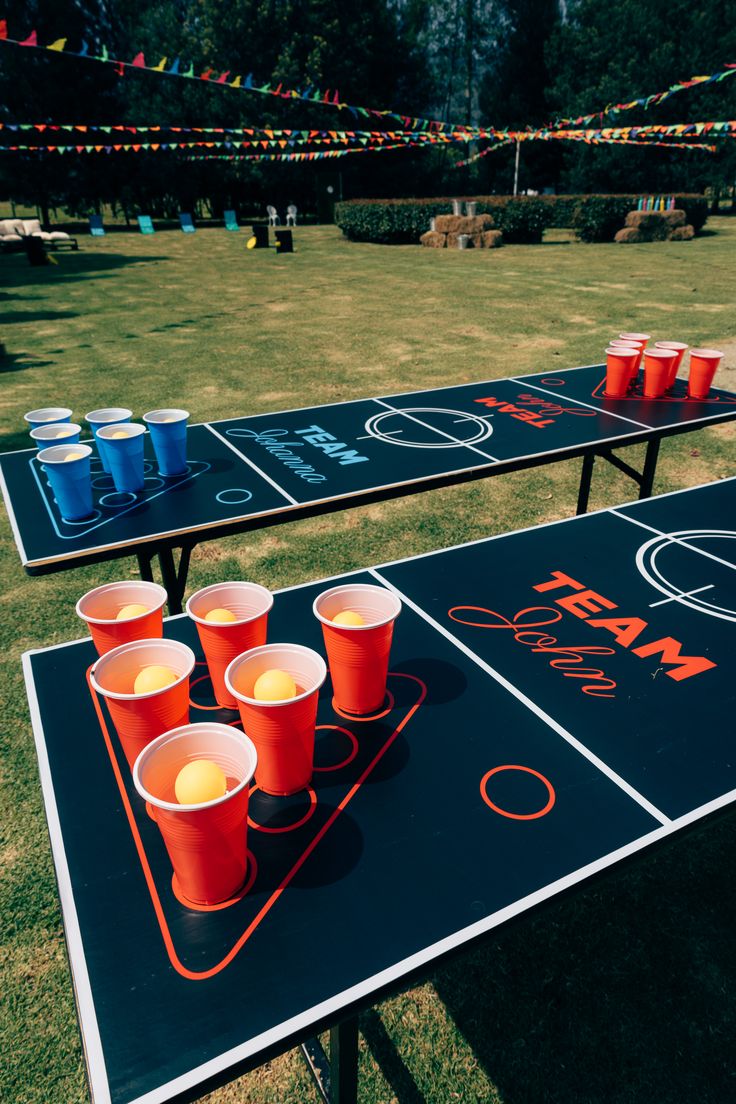 Beer Pong drinking game — two teams throwing a ping pong ball into cups arranged in a triangle