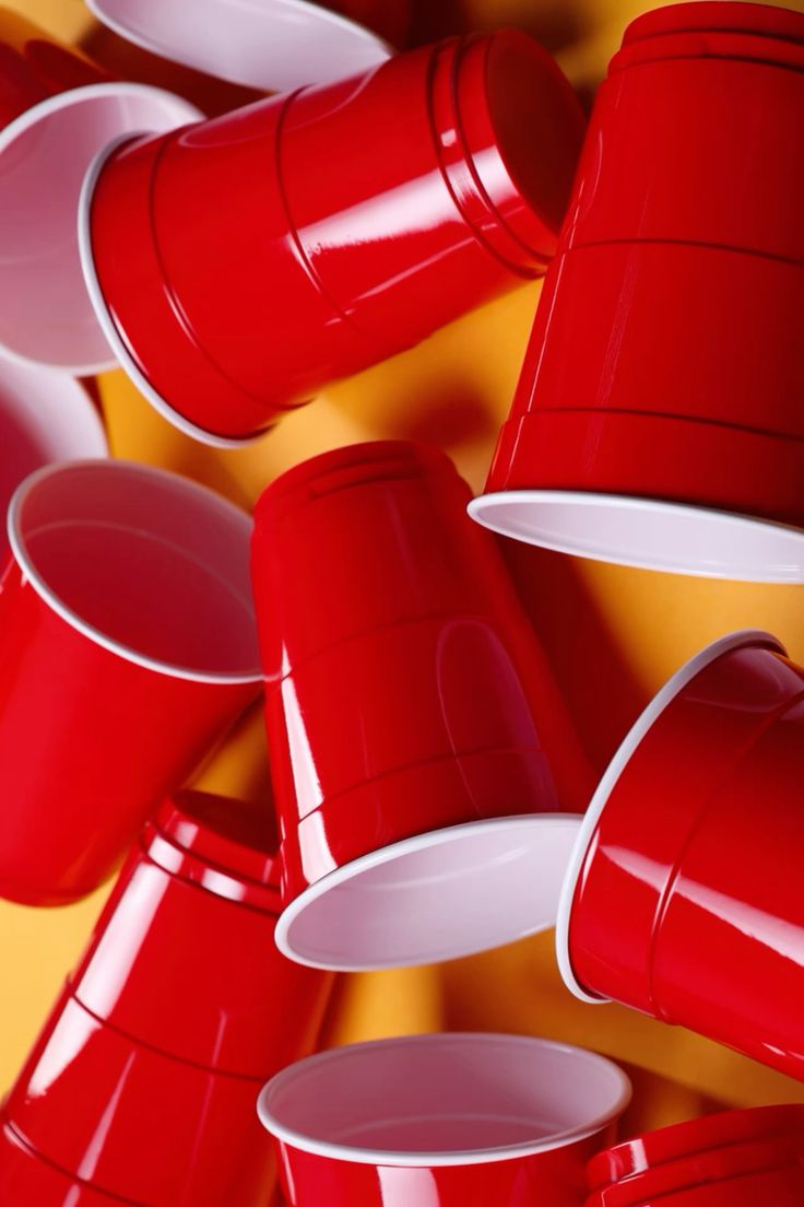 Flip Cup drinking game — two teams racing to flip cups upside-down along a table